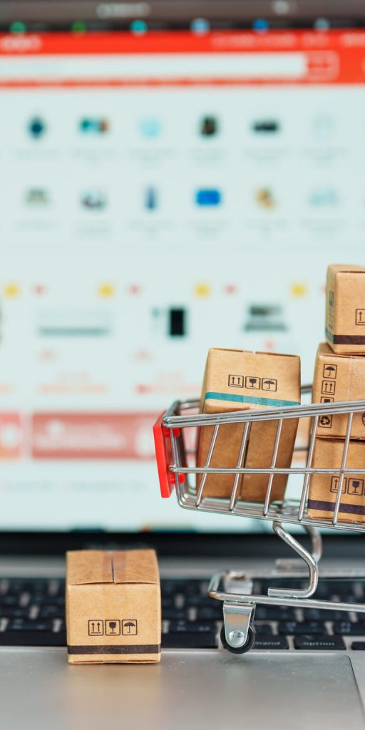 Boxes with shopping cart on a laptop computer. online shopping, Marketplace platform website, technology, ecommerce, shipping delivery, logistics and online payment concepts